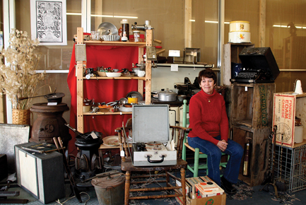Sue Cummings, owner of Coastal Antiques and Collectibles, with a very small portion of her historic collection